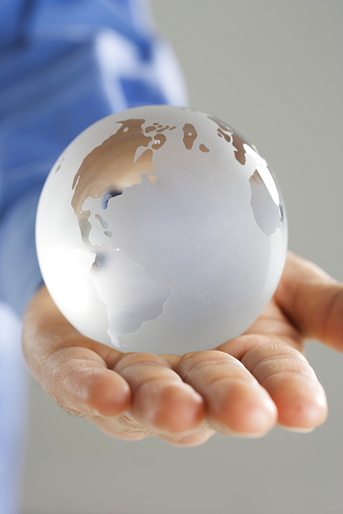 Closeup of glass globe in palm