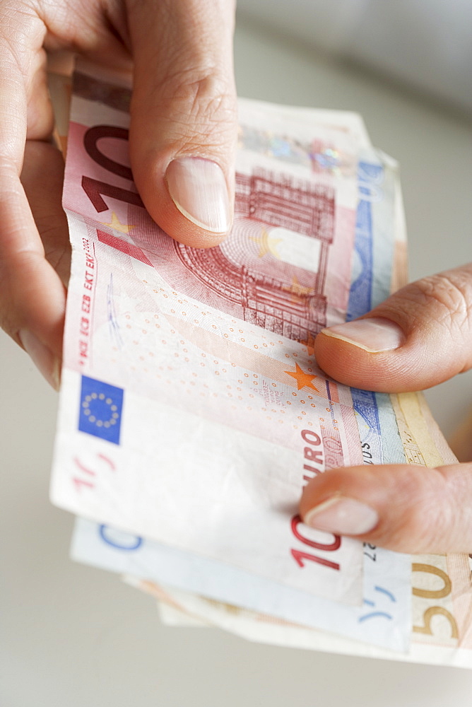 Closeup of hands with European money