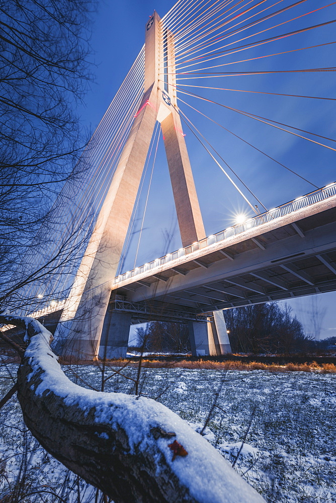 Poland, Subcarpathia, Rzeszow, Suspension bridge at night in winter