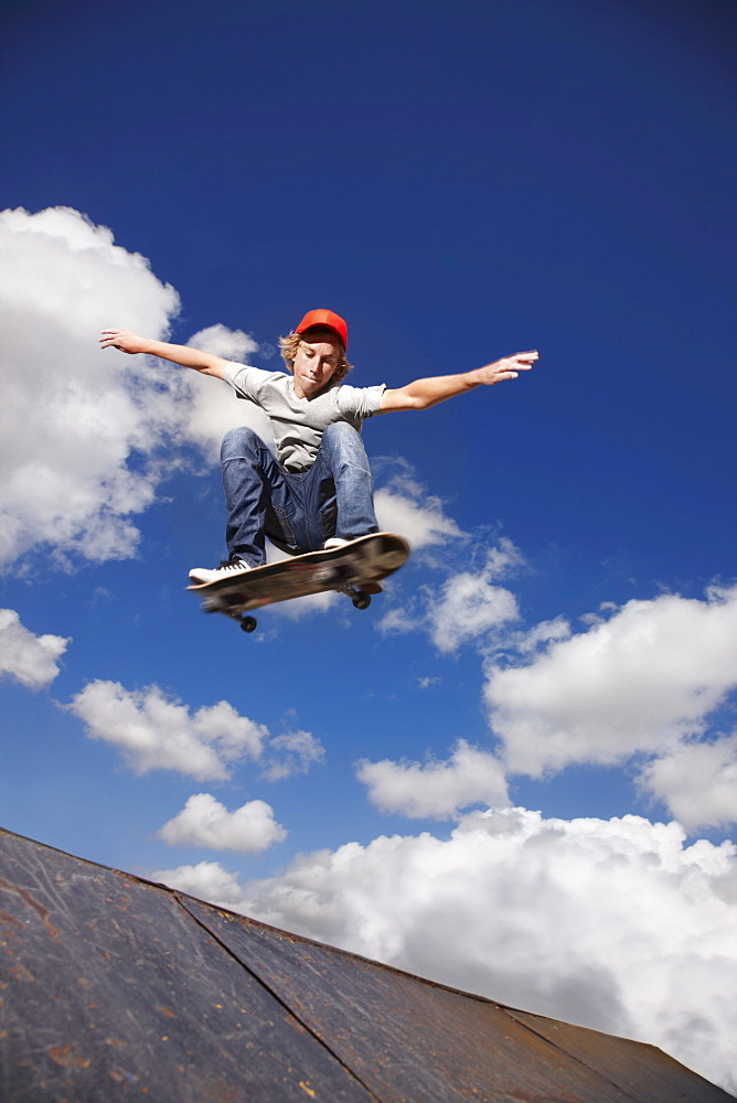 Young man on skateboard jumping