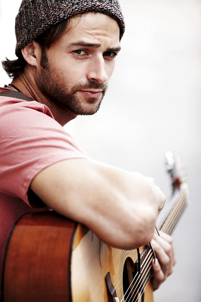 Portrait of musician playing guitar outdoors