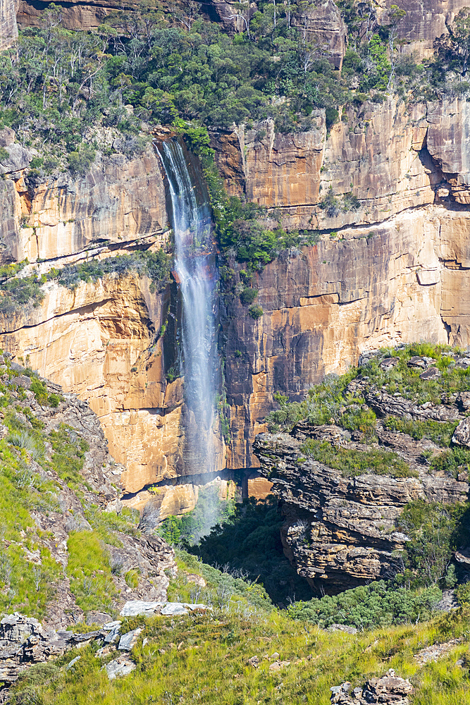 Waterfall on rock face on sunny day