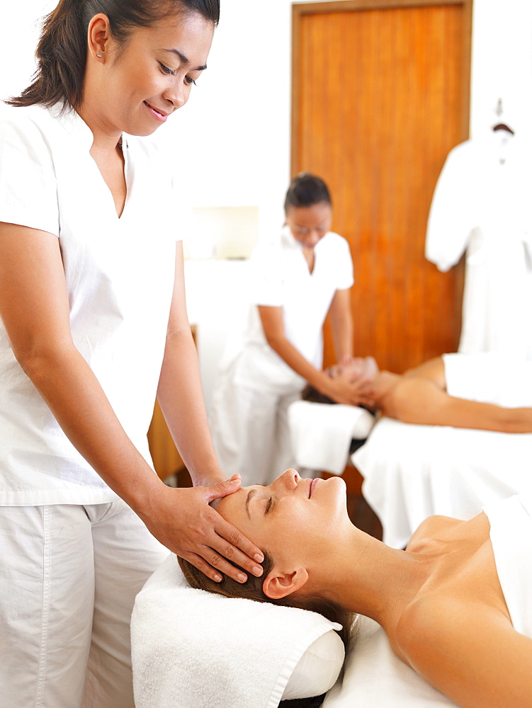 Two people getting massage in spa