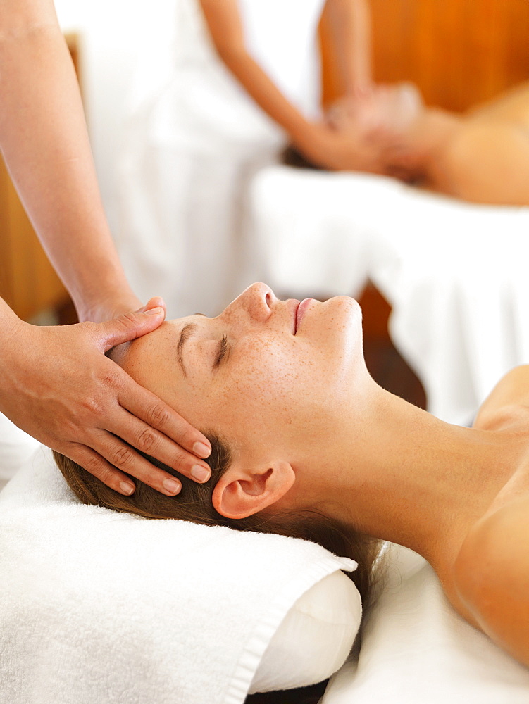 Two people getting massage in spa