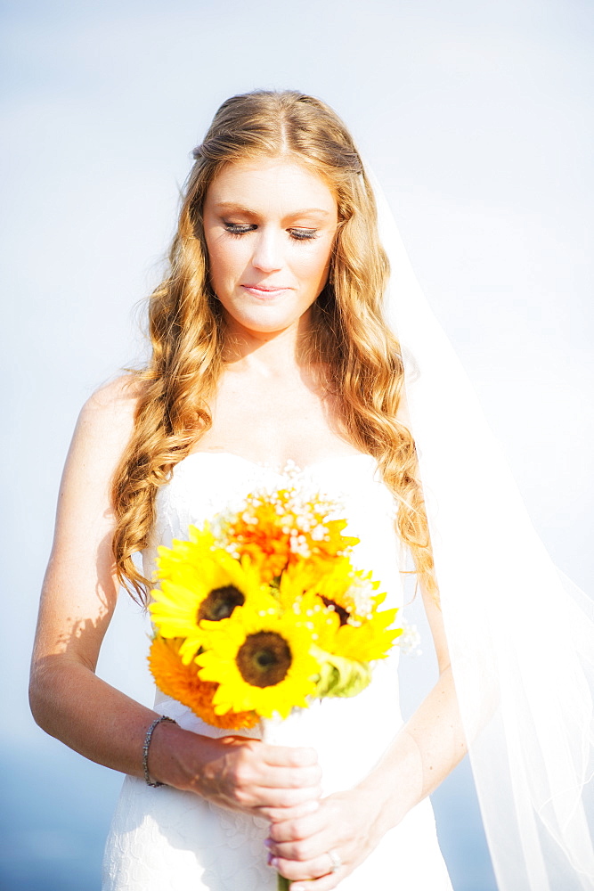 Portrait of bride holding sunflower bouquet