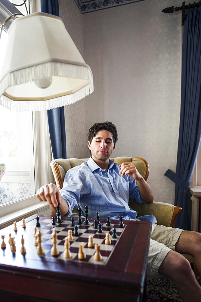 Portrait of young man playing chess