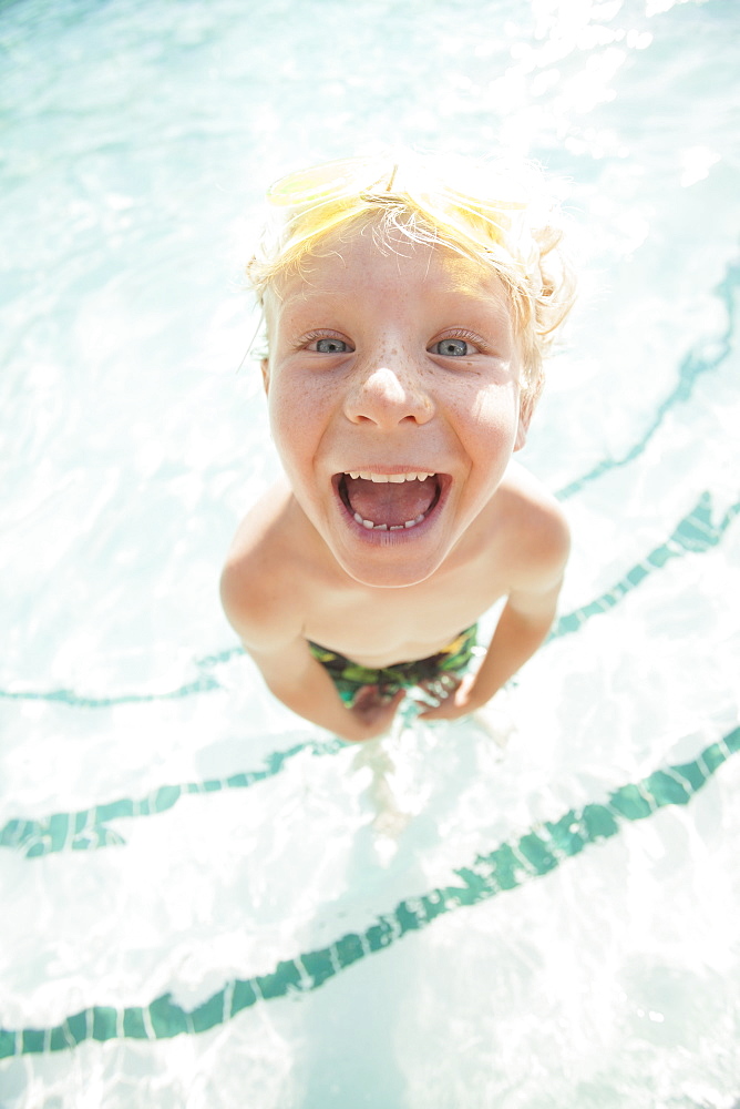 Boy (4-5) posing in swimming pool