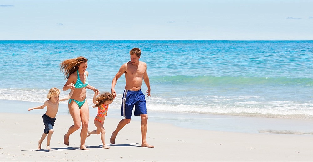 Young family walking on the beach
