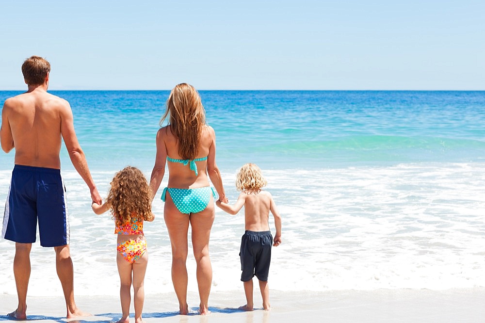 Family standing in front of the sea