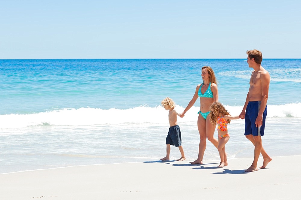 Family walking along the sea
