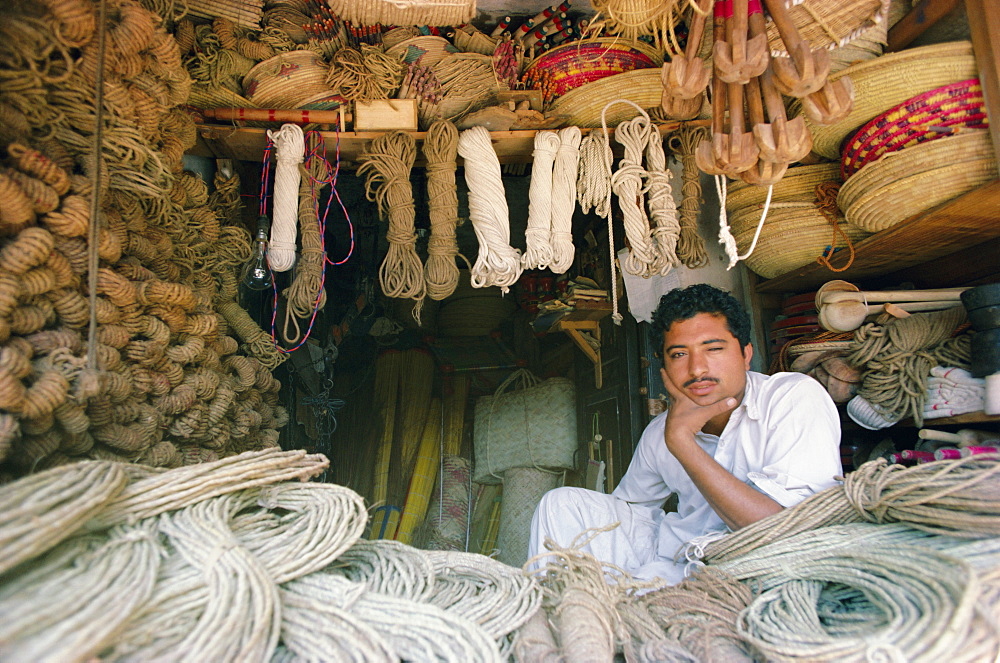 Stallholder selling rope, twine and baskets in the market, Karachi, Sind (Sindh), Pakistan, Asia