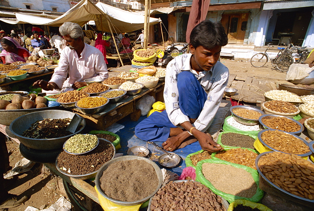 Young man selling nuts and spices, Jodhpur, Rajasthan state, India, Asia