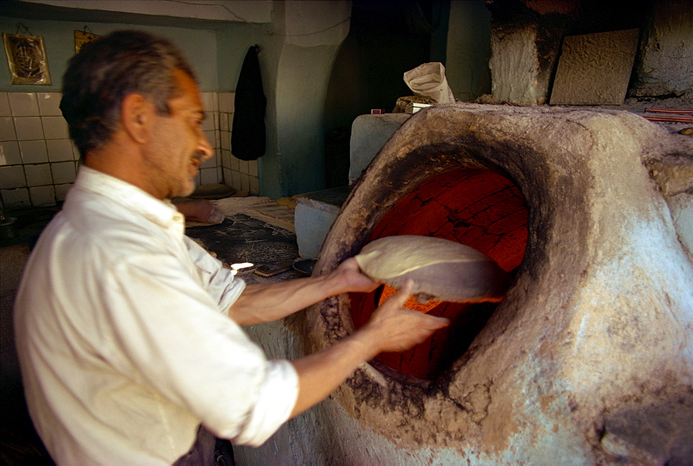 Man baking bread, Iran, Middle East