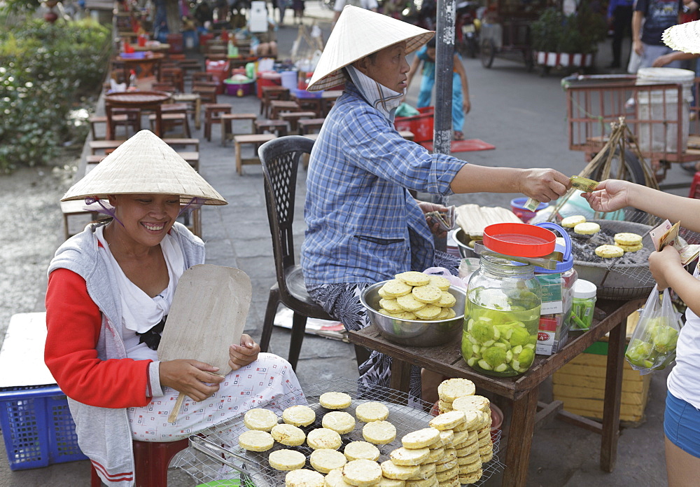 Women sell hot potato snacks in the Ancient Town, Hoi An, Vietnam, Indochina, Southeast Asia, Asia