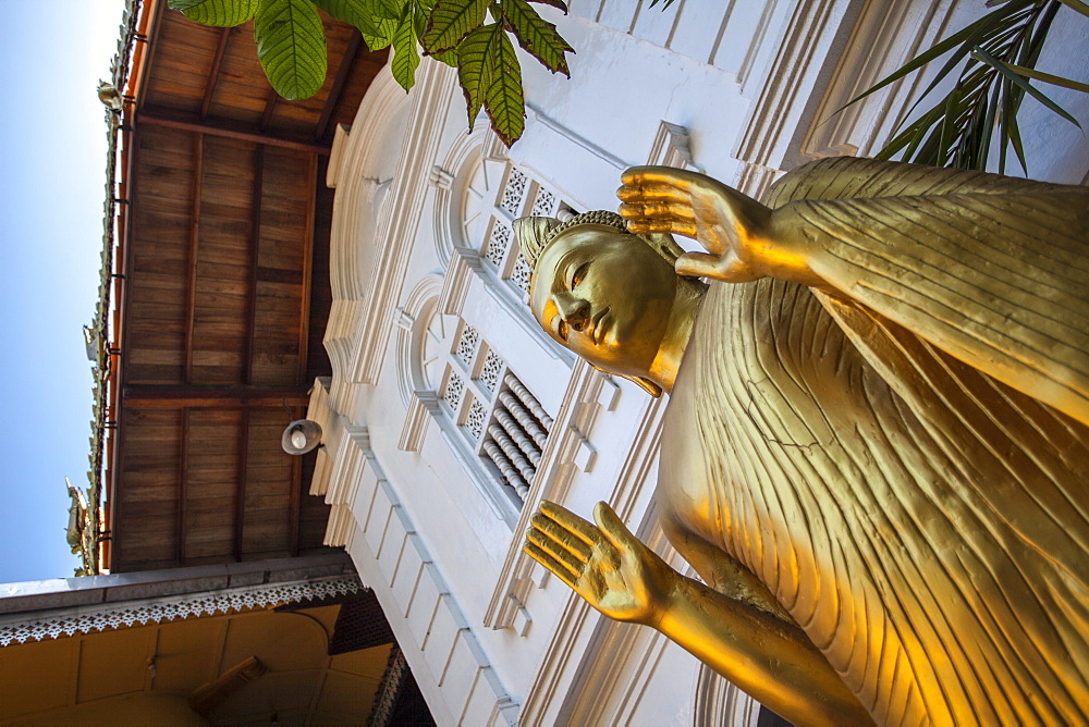 Golden statue at the entrance of Gangaramaya Temple, Colombo, Sri Lanka, Asia 