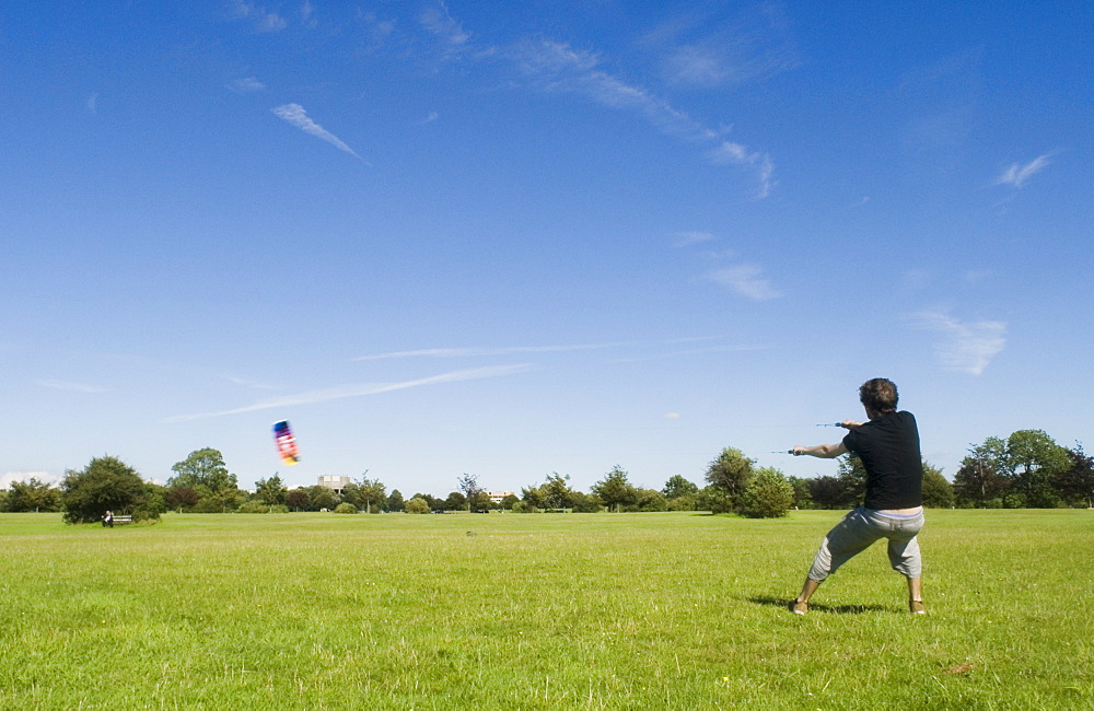 Man flying power kite on the Downs, Bristol, UK