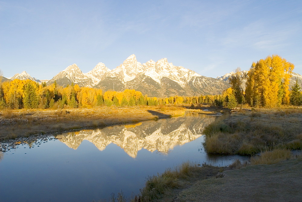 Grand Teton mountains reflected in Snake River at dawn, Wyoming, USA