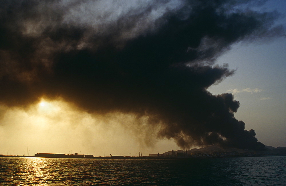 Oil refindery on fire.  Island in Arabian Gulf