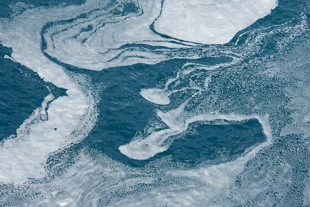 Tidal currents showing in natural patterns (of dead plankton).  Walker Bay, Western Cape, South Africa.