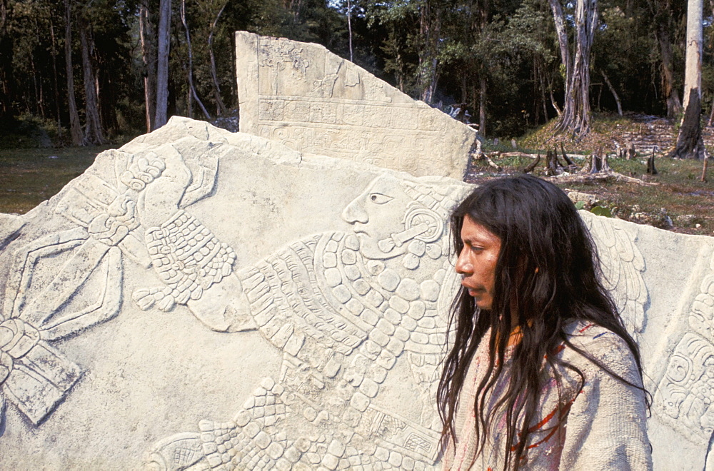 Lacandon Indian from Bonampak in front of Mayan stele, Mexico, North America