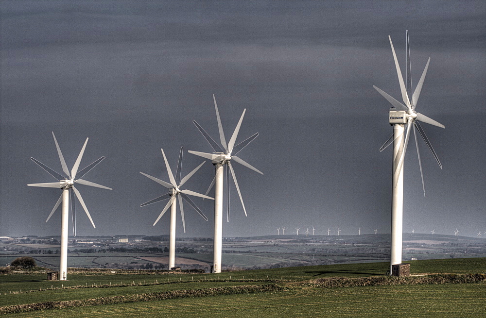 Wind turbine and setting sun, Carland Cross wind Farm nr Truro,Cornwall, uk. MORE INFO 15  Vestas turbines, built 1992, one of oldest wind farms in uk