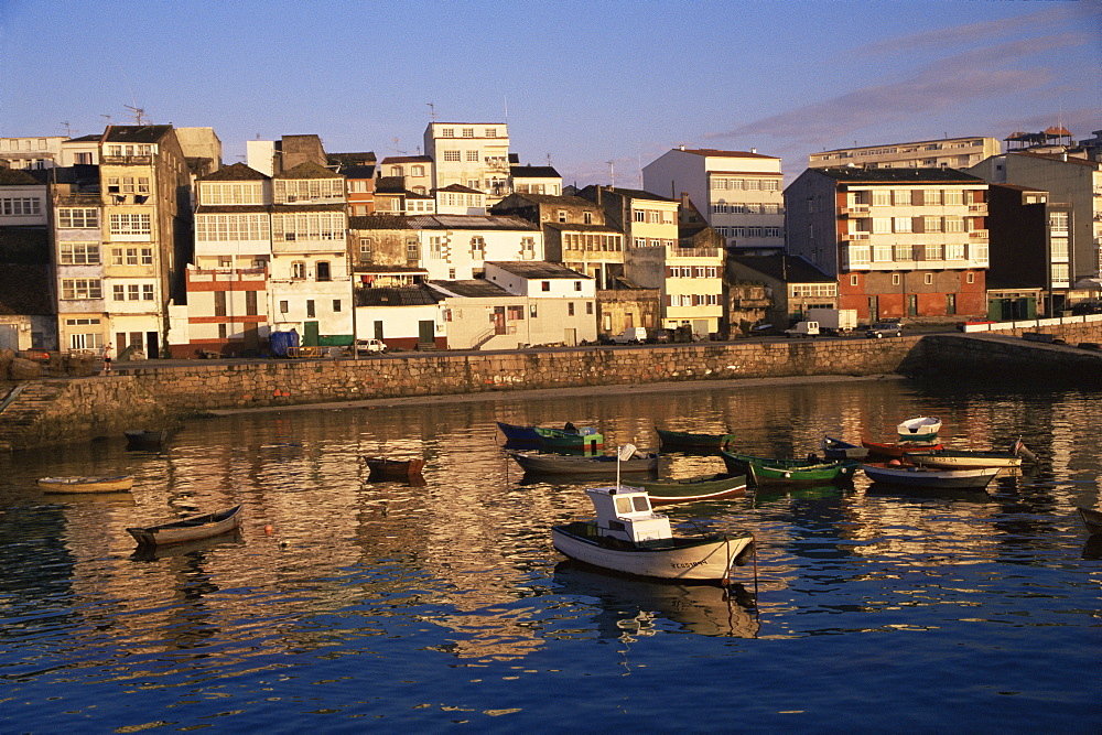 Town across fishing boat harbour, Finisterre (Fisterra), Galicia, Spain, Europe