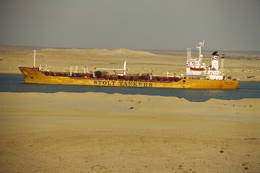 Tanker passing through Suez Canal with desert on either side, Egypt, North Africa, Africa