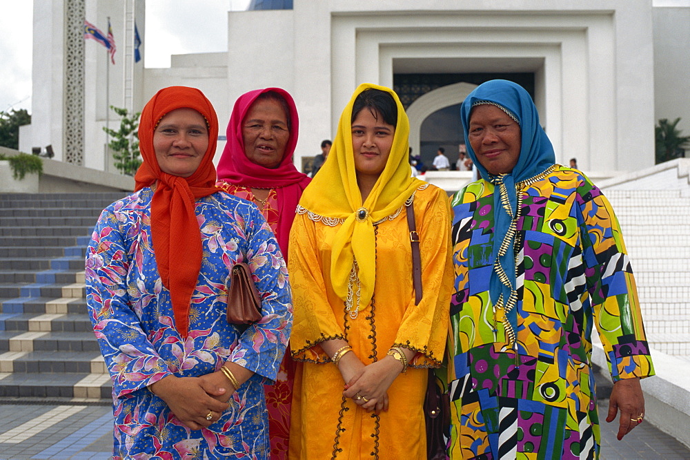 Four women in traditional Muslim Malay dress, Kuala Lumpur, Malaysia, Southeast Asia, Asia