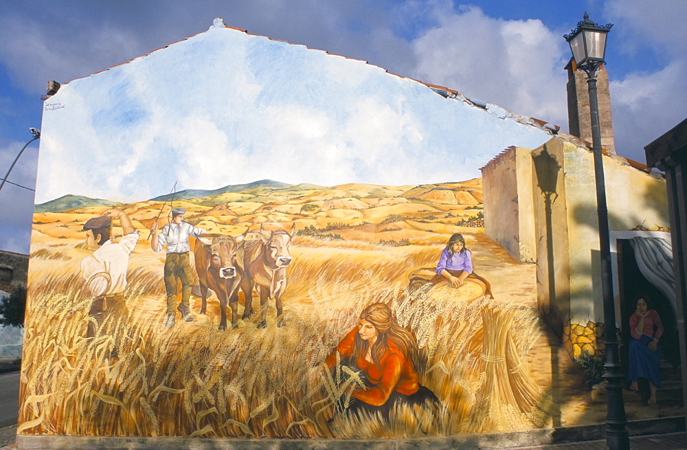 Painting by Pina Monne on side of house, evoking nostalgia for harvests in the rural past, Tinnura village, near Bosa, Sardinia, Italy, Europe