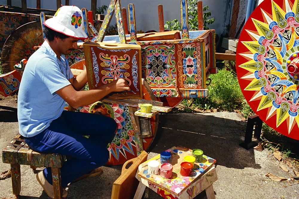 Portrait of a man with his paint pots painting traditional designs, at Sarchi in Costa Rica, Central America