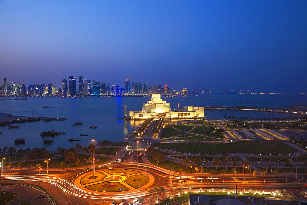 Traffic at roundabout in front of the Museum of Islamic Art at night, Doha, Qatar, Middle East