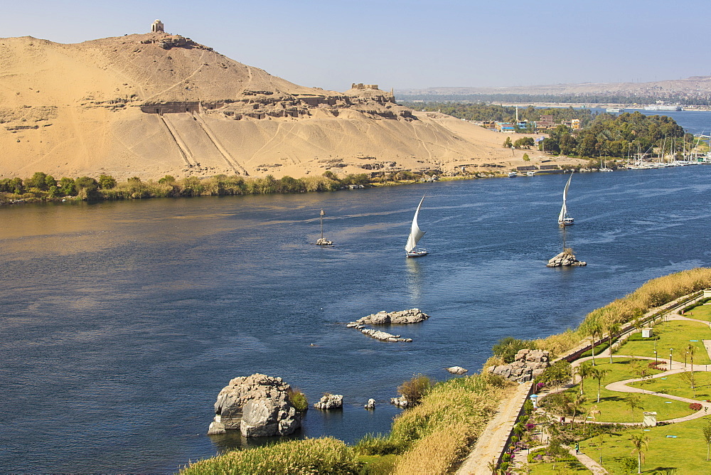 View of River Nile, Tombs of the Nobles on the West Bank, Elephantine Island, and the gardens of the Movenpick Resort, Aswan, Upper Egypt, North Africa, Africa