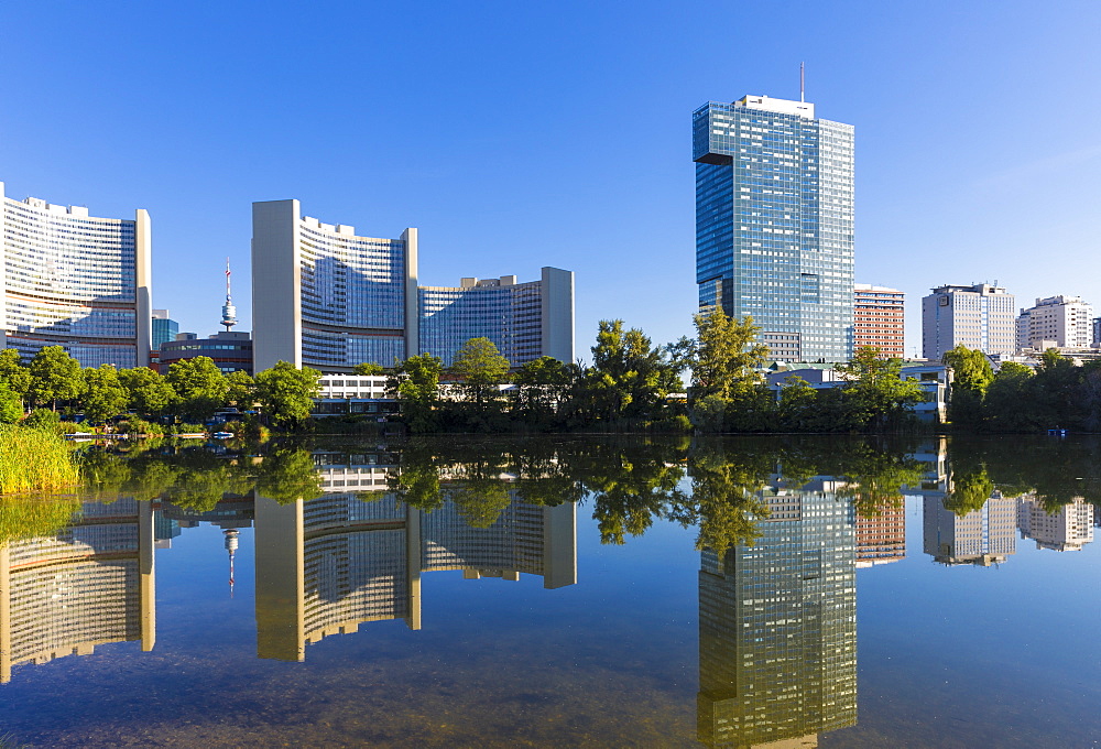 United Nations buildings reflected in lake, UNO City, Vienna, Austria, Europe