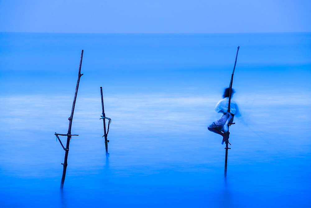 Stilt fisherman fishing at Midigama near Weligama, South Coast, Sri Lanka, Indian Ocean, Asia