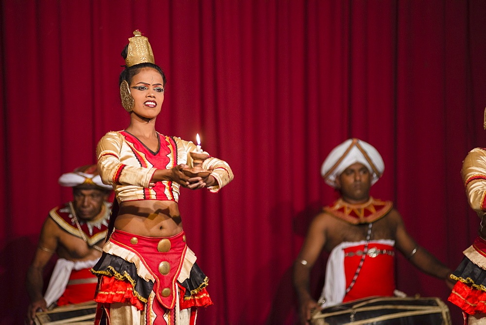 Woman dancing traditional Kandyan dance at a tourist show in Kandy, Sri Lanka, Asia