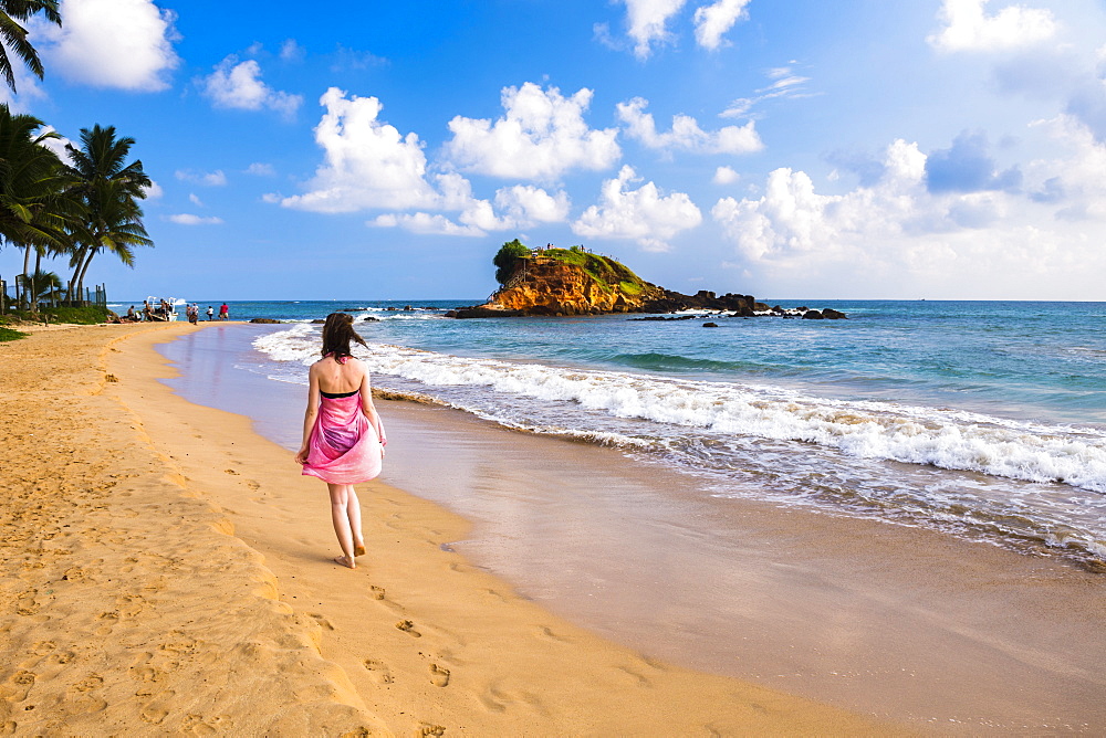 Tourist walking along Mirissa Beach, South Coast, Sri Lanka, Asia 