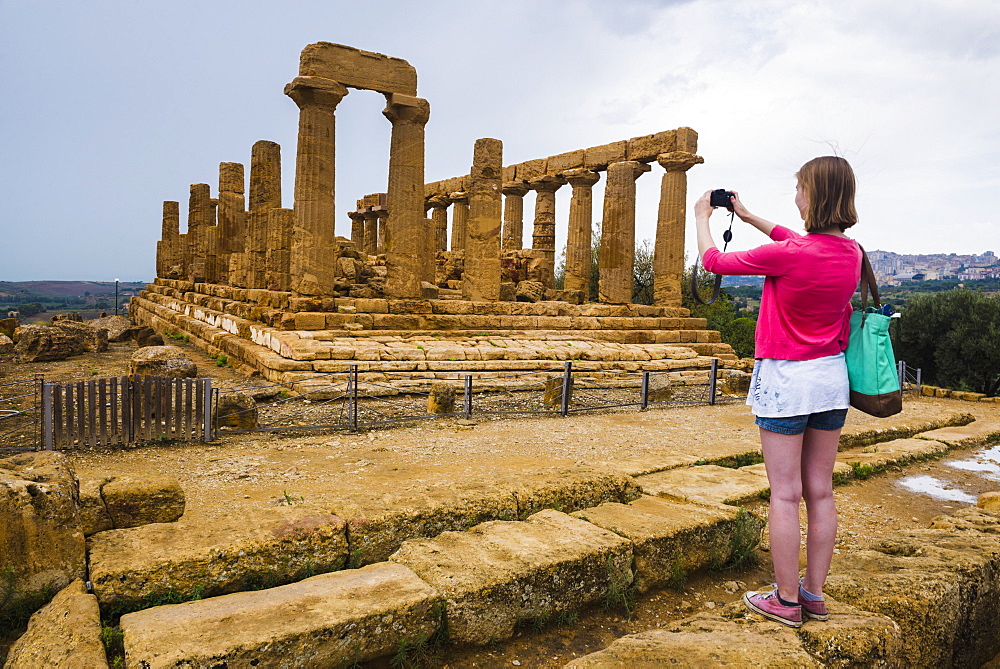 Tourist taking a photo at Temple of Juno, Valley of the Temples (Valle dei Templi), Agrigento, UNESCO World Heritage Site, Sicily, Italy, Europe 