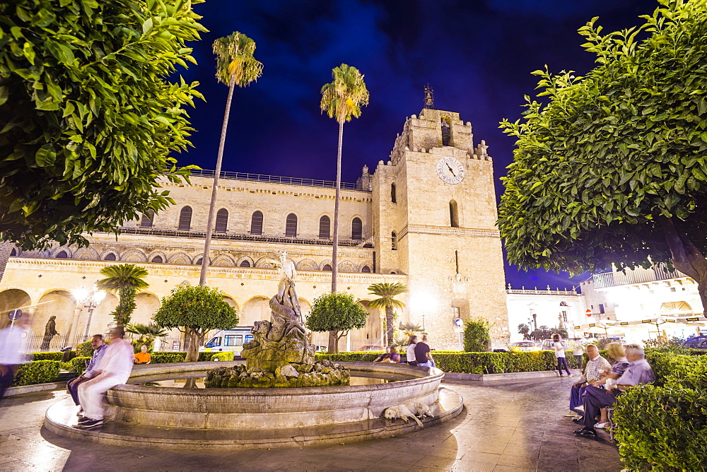 Monreale Cathedral at night, Sicilian people at the fountain in Guglielmo Square, Monreale, near Palermo, Sicily, Italy, Europe