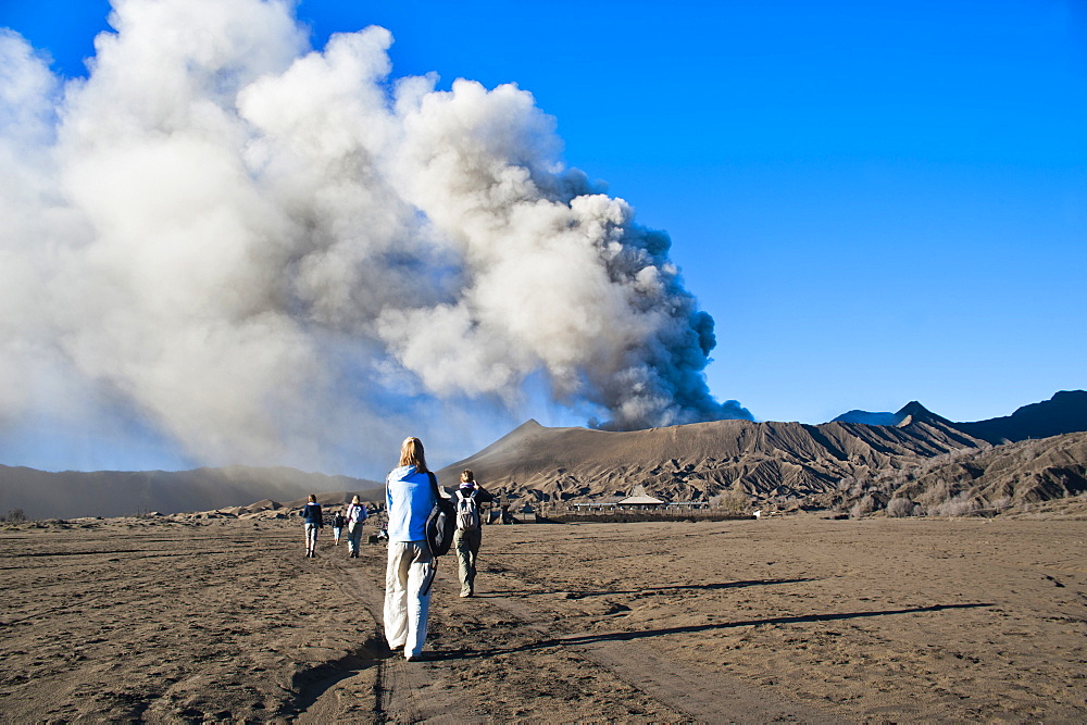 Tourists watching Mount Bromo, an active volcano, erupting in East Java, Indonesia, Southeast Asia, Asia