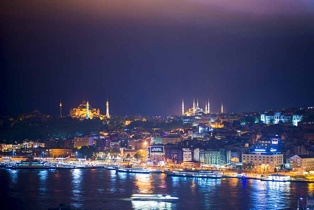 Blue Mosque (Sultan Ahmet Mosque) and Hagia Sophia (Aya Sofya) at night seen from The Galata Tower across the Bosphorus Strait, Istanbul, Turkey, Europe