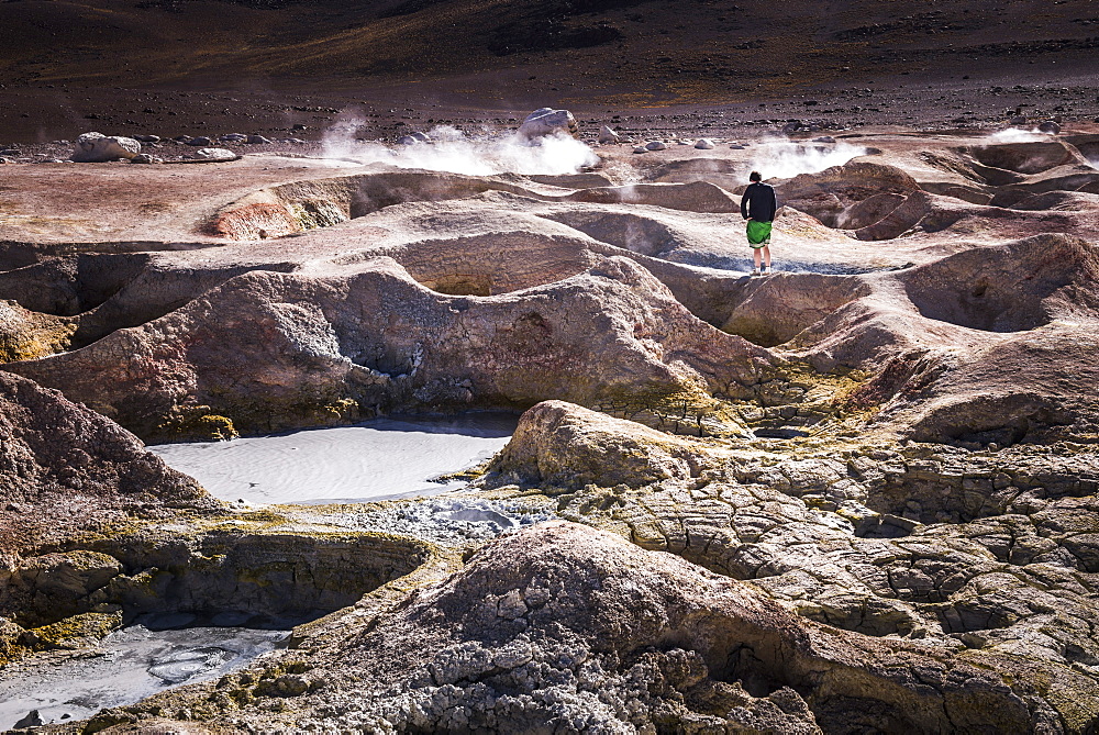 Tourist at Sol de Manana Geothermal Basin area, Altiplano of Bolivia, South America