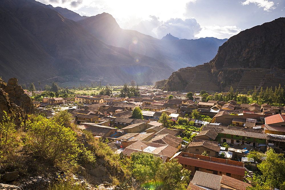 Ollantaytambo Inca Ruins at sunset seen behind Ollantaytambo Town, Sacred Valley of the Incas, near Cusco, Peru, South America