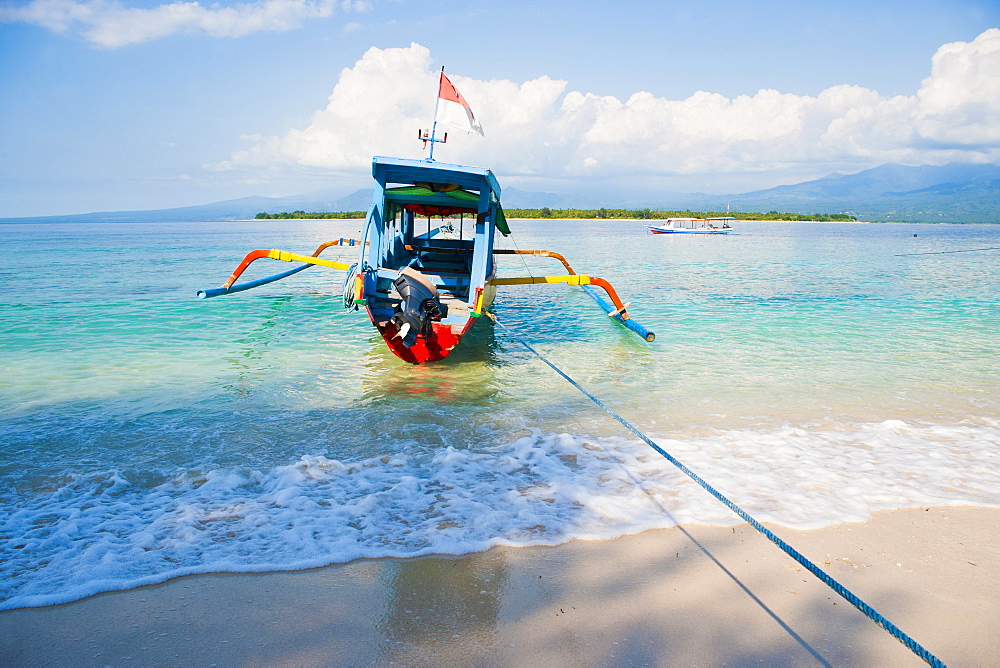 Gili Meno, a traditional Indonesian boat on Gili Meno with Gili Air and Lombok in the background, Gili Islands, Indonesia, Southeast Asia, Asia