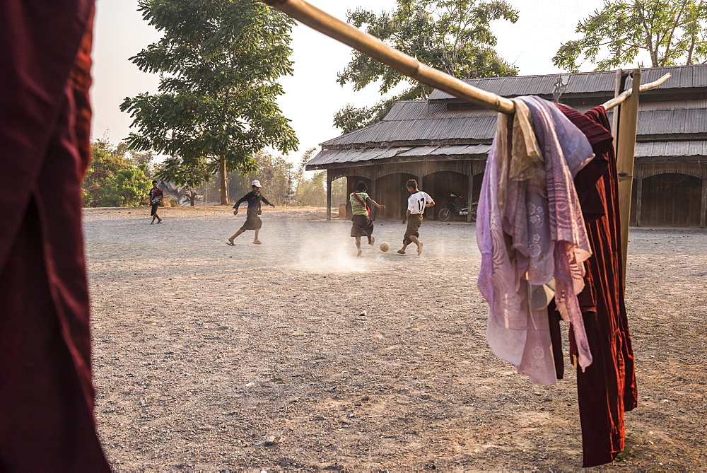 Novice monks playing football at a Buddhist Monastery between Inle Lake and Kalaw, Shan State, Myanmar (Burma), Asia