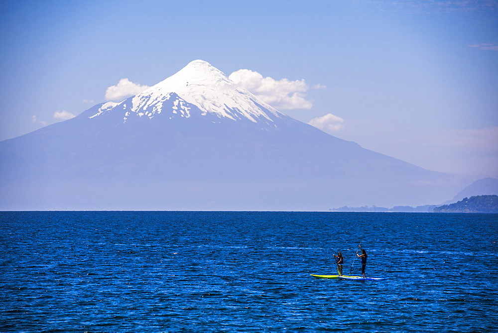 Paddleboarding on Llanquihue Lake with Osorno Volcano (Volcan Osorno) behind, Puerto Varas, Chile Lake District, Chile, South America