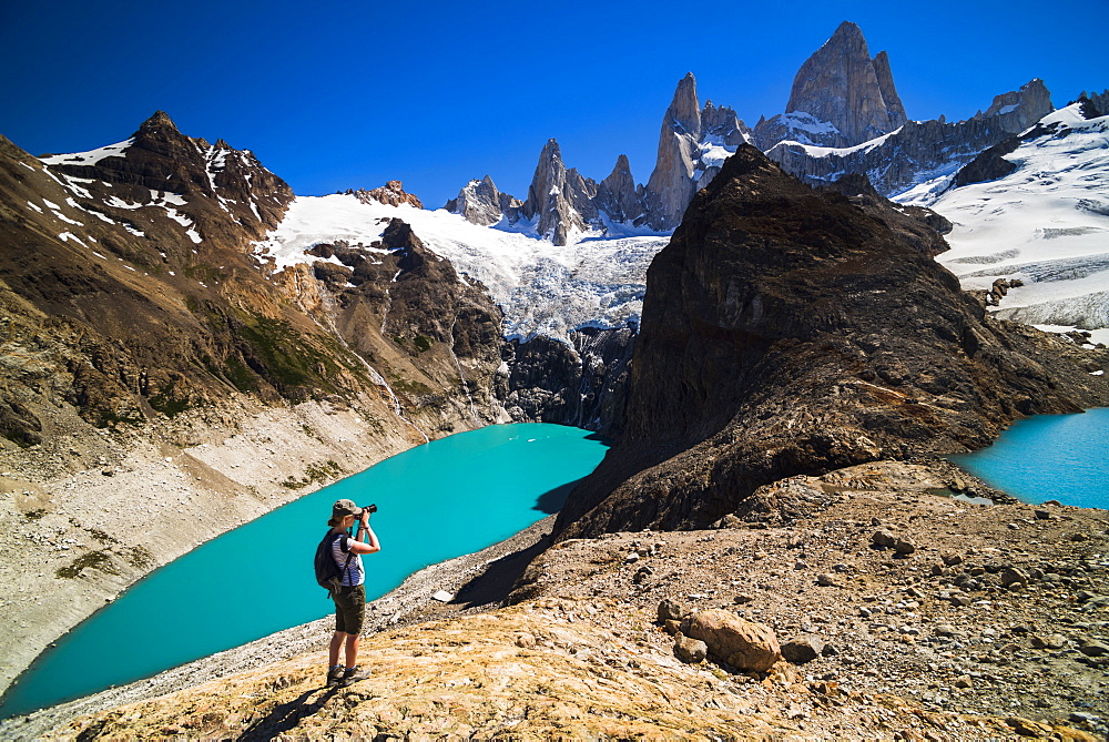 Hiker taking a photo of Mount Fitz Roy (Cerro Chalten), El Chalten, Patagonia, Argentina, South America