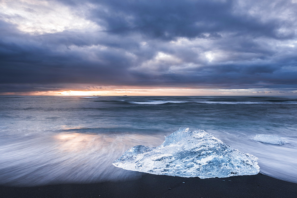 Iceberg at sunrise on Jokulsarlon Beach, a black volcanic sand beach in South East Iceland, Iceland, Polar Regions