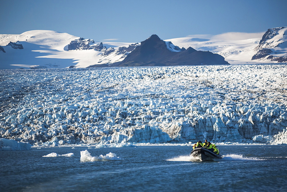 Zodiac boat tour on Jokulsarlon Glacier Lagoon, with Breidamerkurjokull Glacier and Vatnajokull Ice Cap behind, South East Iceland, Iceland, Polar Regions