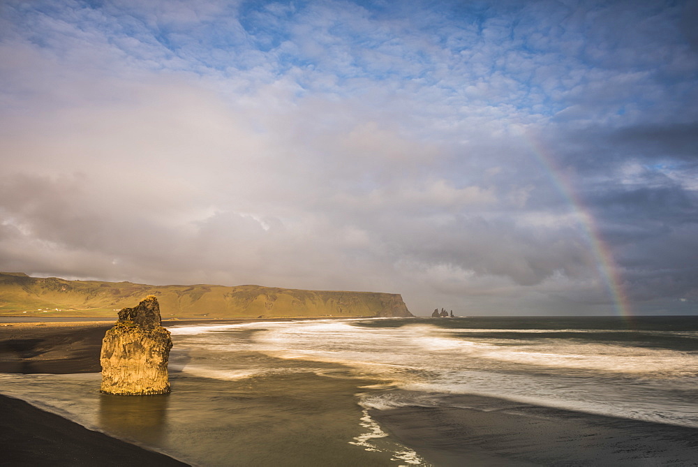 Reynisdrangar Basalt Sea Stacks and rainbow seen from Dyrholaey Peninsula at sunset, near Vik, South Iceland (Sudurland), Iceland, Polar Regions