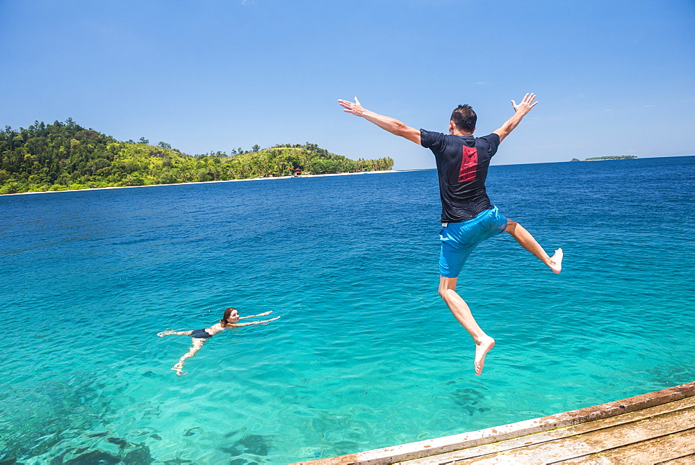 Jumping into the sea and playing in the ocean at Twin Beach, a tropical white sandy beach near Padang in West Sumatra, Indonesia, Southeast Asia, Asia